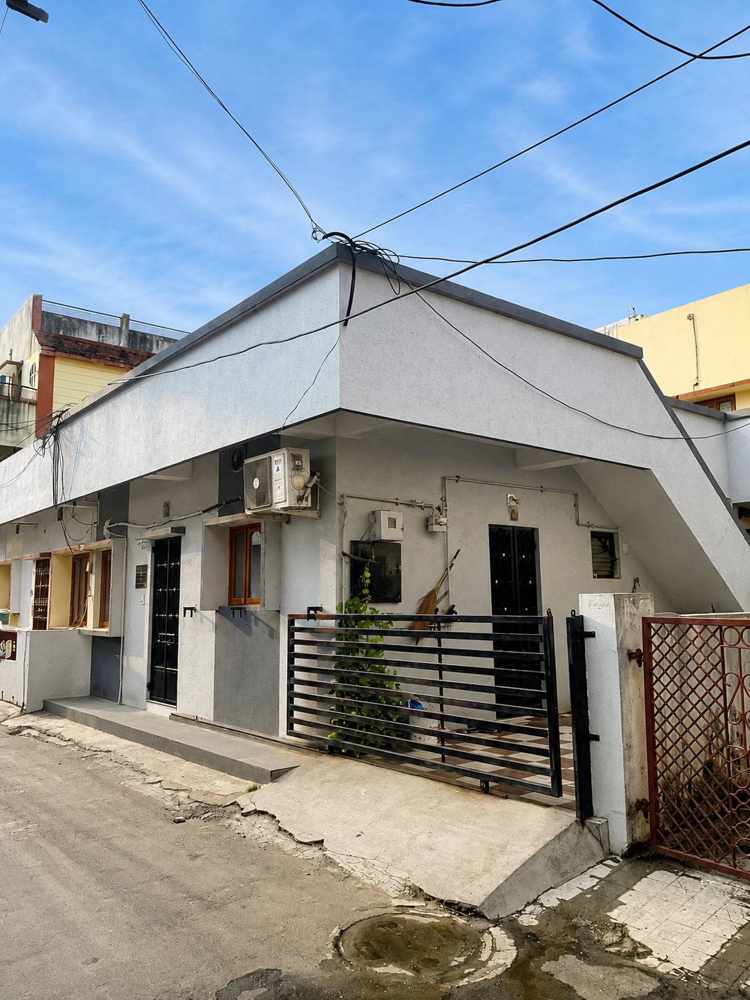 Ashok Vatika residence exterior before renovation, corner view with gate